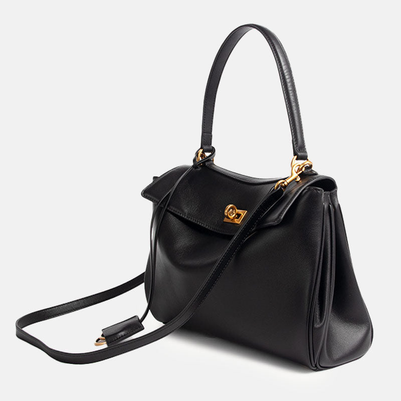 Elegante schwarze Handtasche mit goldfarbener Schließe